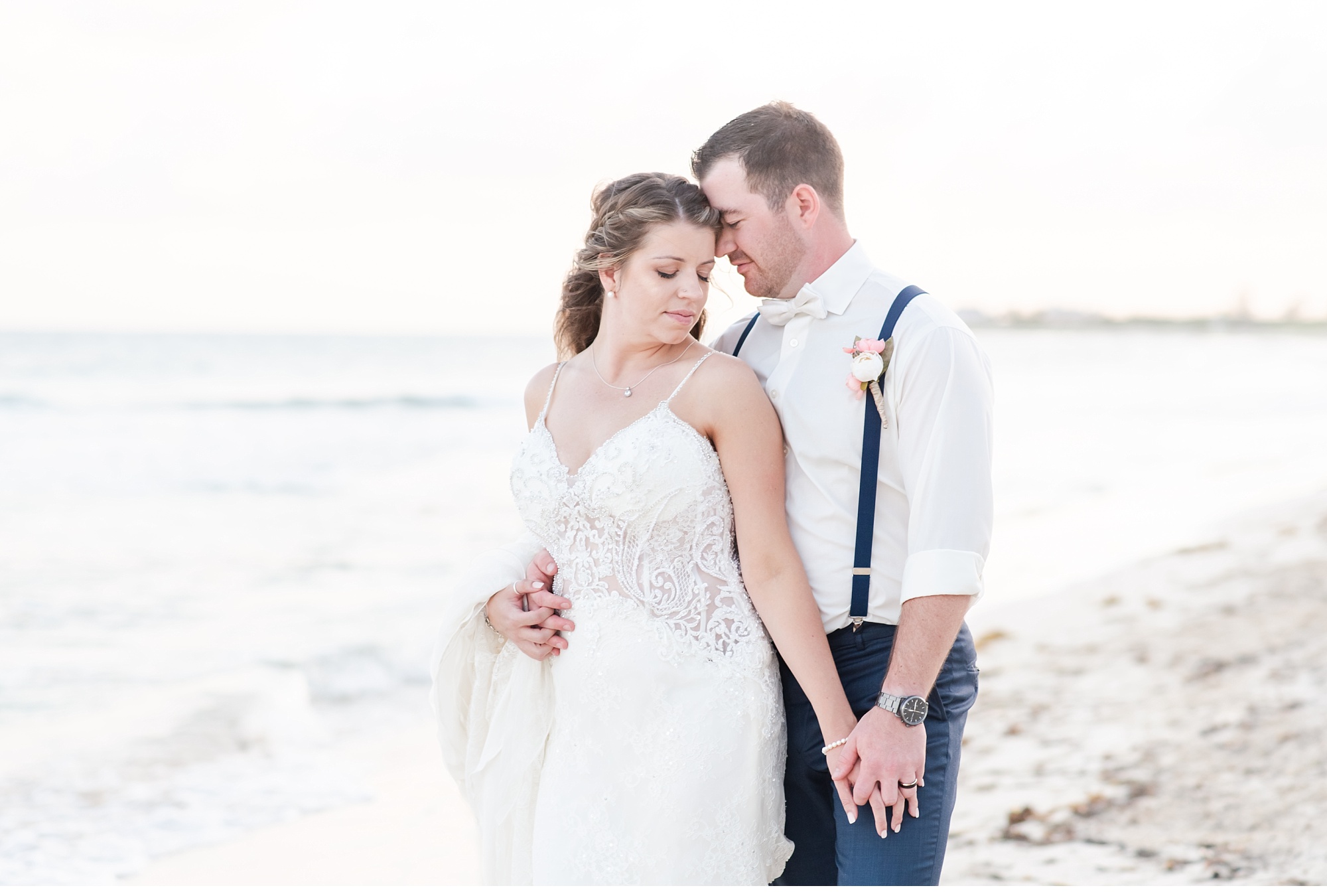 a bride and groom stand on the beach at sunset in cancun mexico. photo used in a blog post about photographers setting business boundaries.