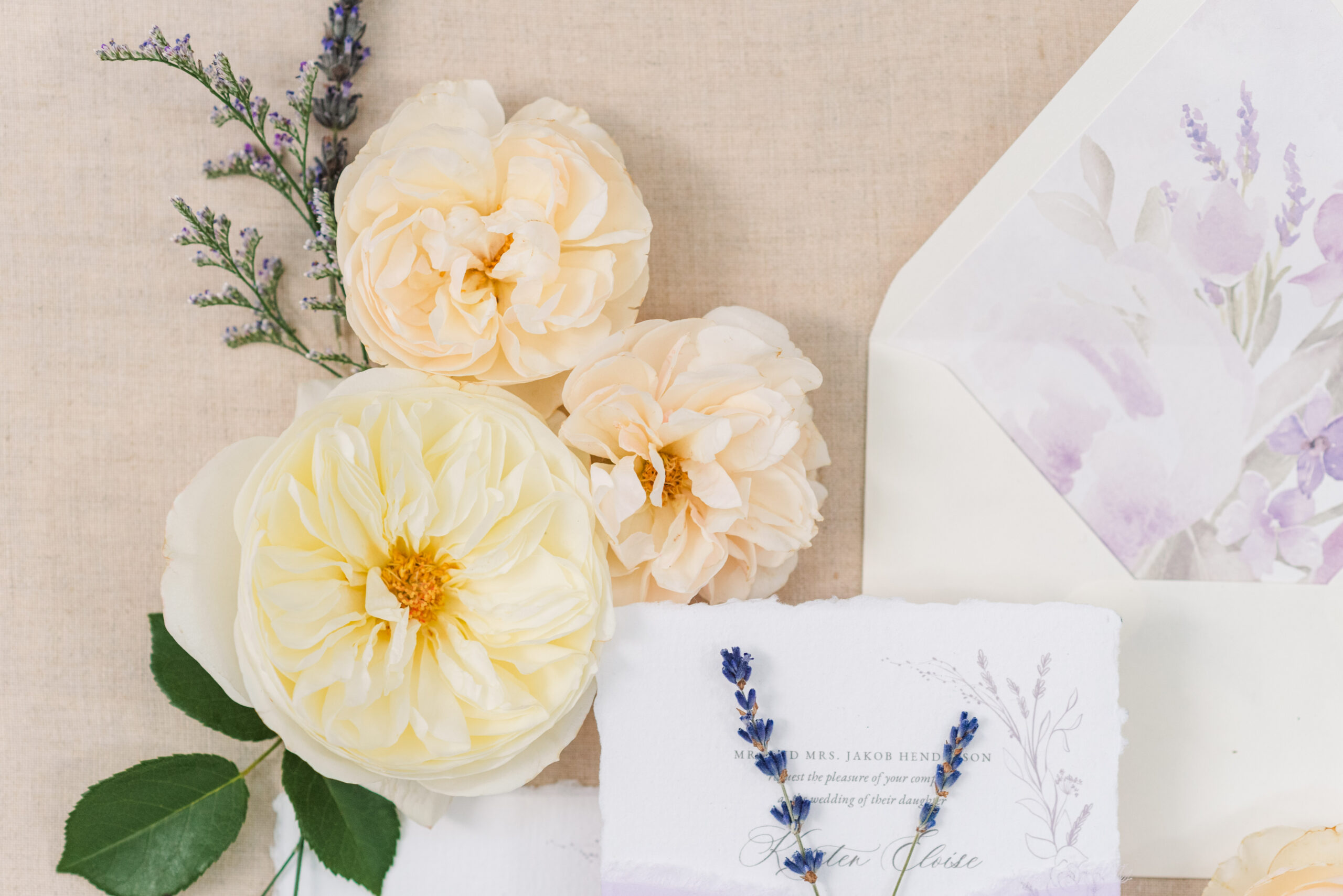 flowers and wedding invitations on a beige background. used in a blog post about wedding photography leads