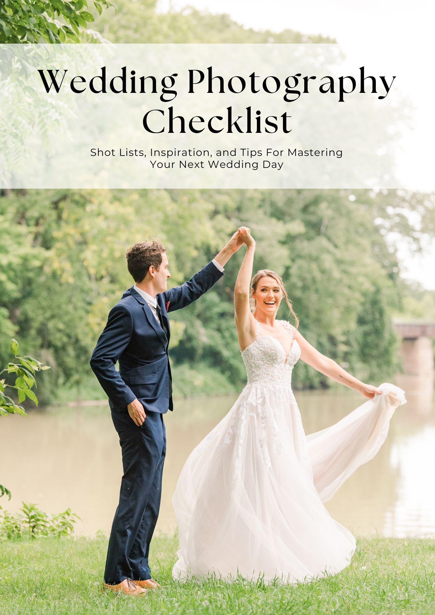 a groom in a navy blue suit twirls a bride around as they stand in front of a river. text above the photo reads wedding photography checklist. the image is used in a blog post about a wedding photo shot list for photographers