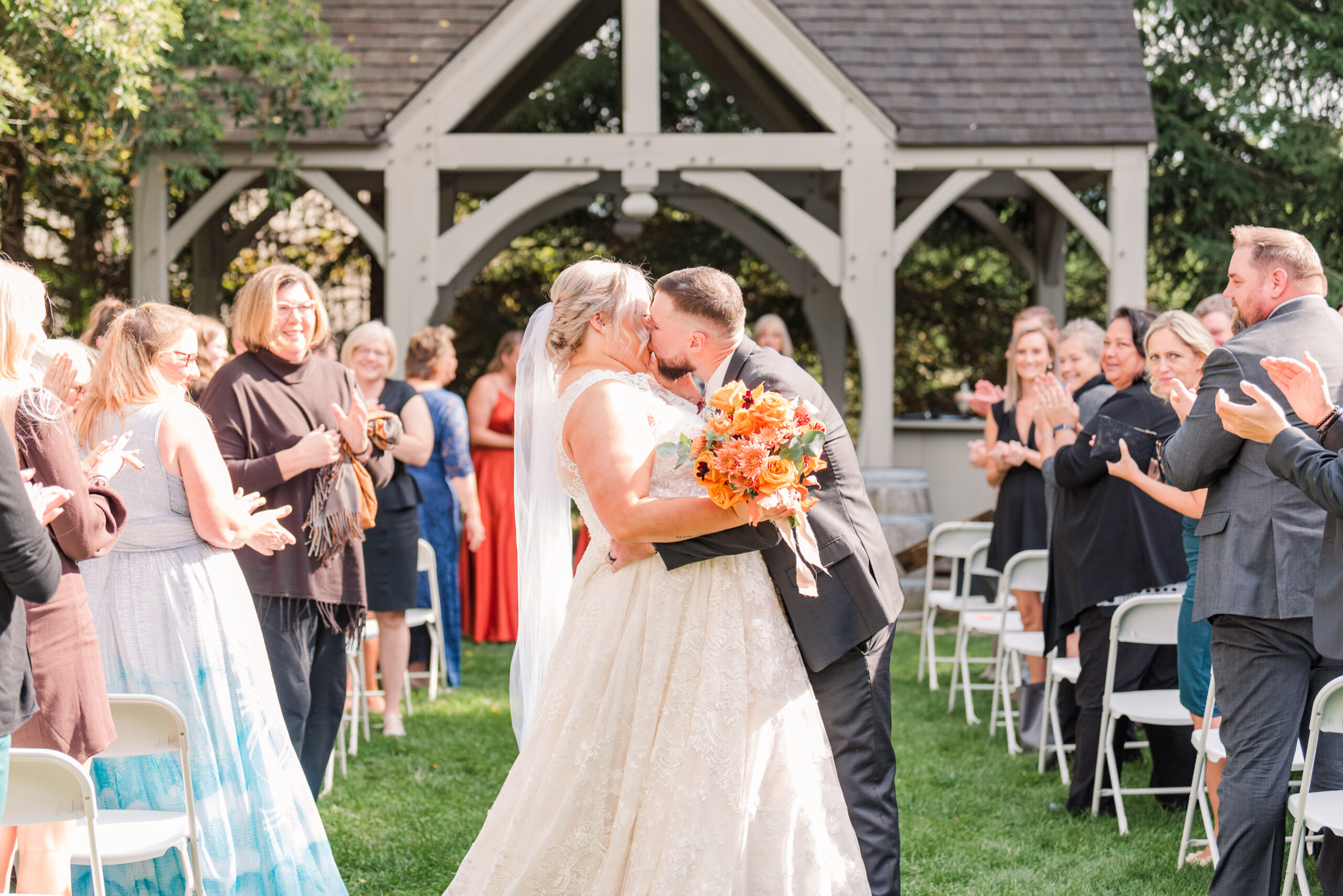 a bride and groom kiss in the aisle at the end of their ceremony at bellamere winery. photo by life is beautiful photography, used in a blog post about making a good first impression on a wedding photography inquiry