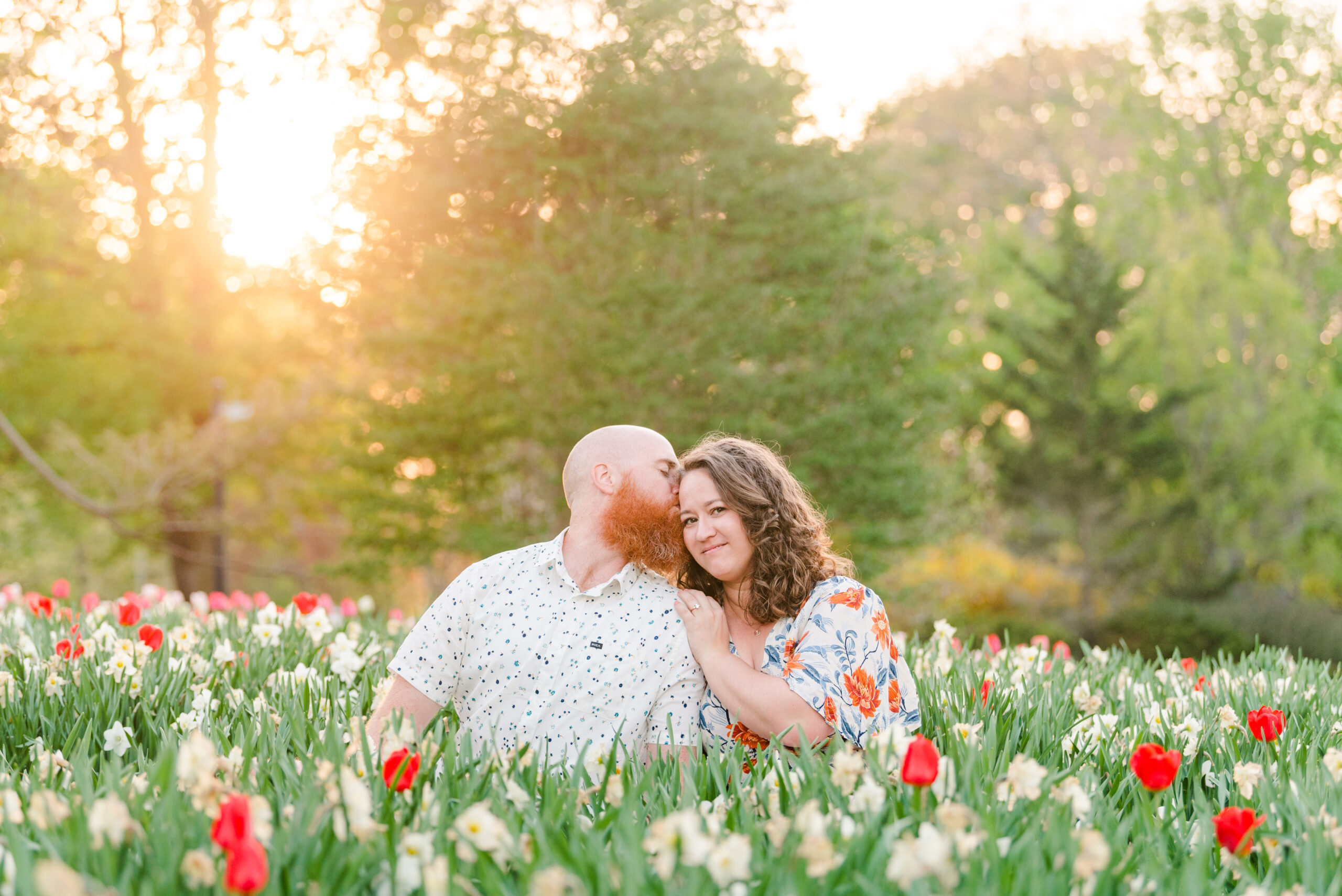 a couple sits on the ground at sunset surrounded by tulips. the photo is used decoratively at the top of a blog post about three things to make your systems successful