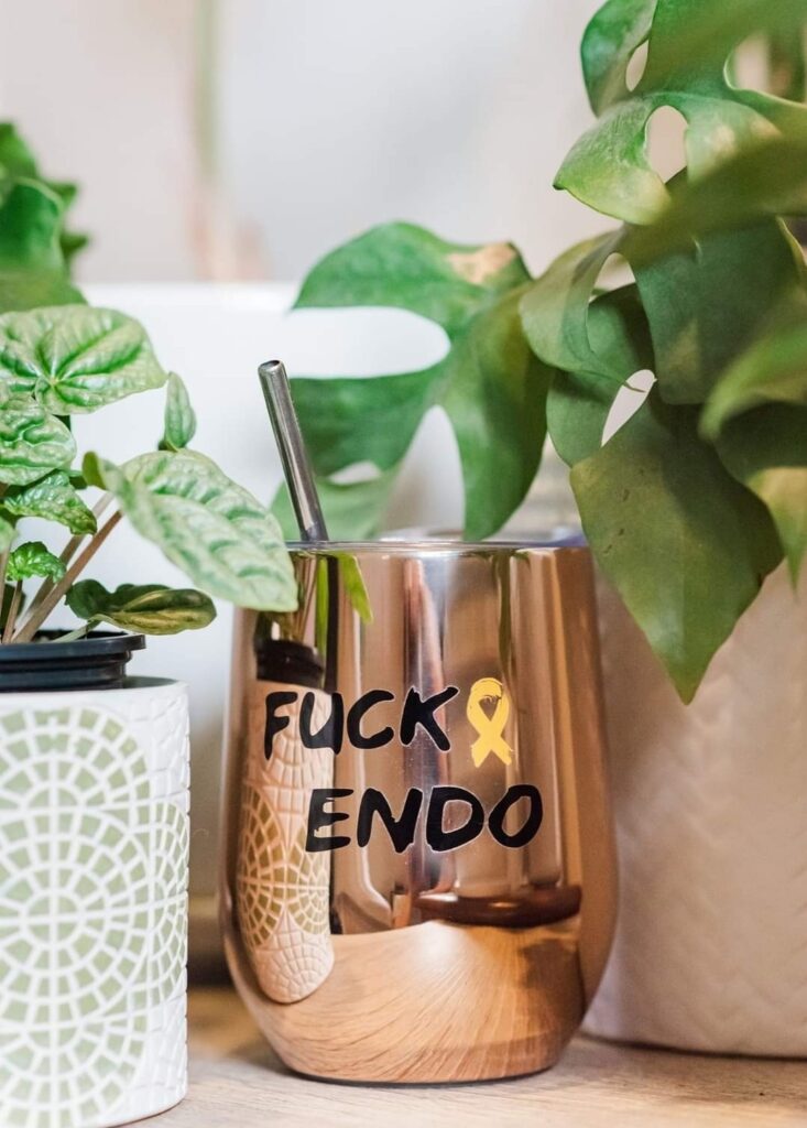 A rose gold cup that says "Fuck Endo" sits between two plants. The photo is used in a post about my endometriosis toolkit.