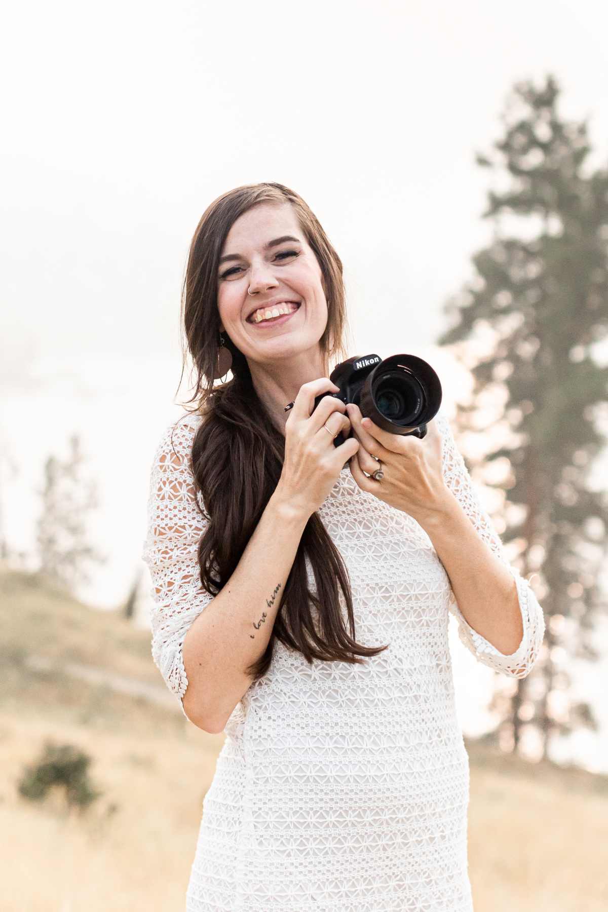 sandra smiles while holding a camera. used in a blog post about the photography client experience.