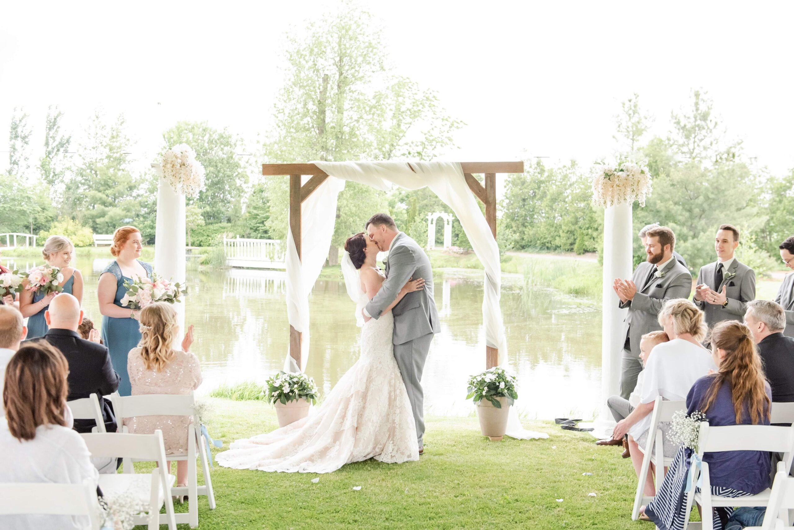 a couple sharing their first kiss on a wedding day, used in a blog post about sustainable wedding photography